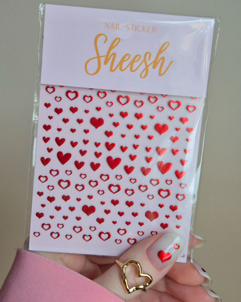 Herz-Nagelsticker von Sheesh Nails mit roten Herzmotiven auf Trägerkarte, gehalten in der Hand, geeignet für romantische Nail Art