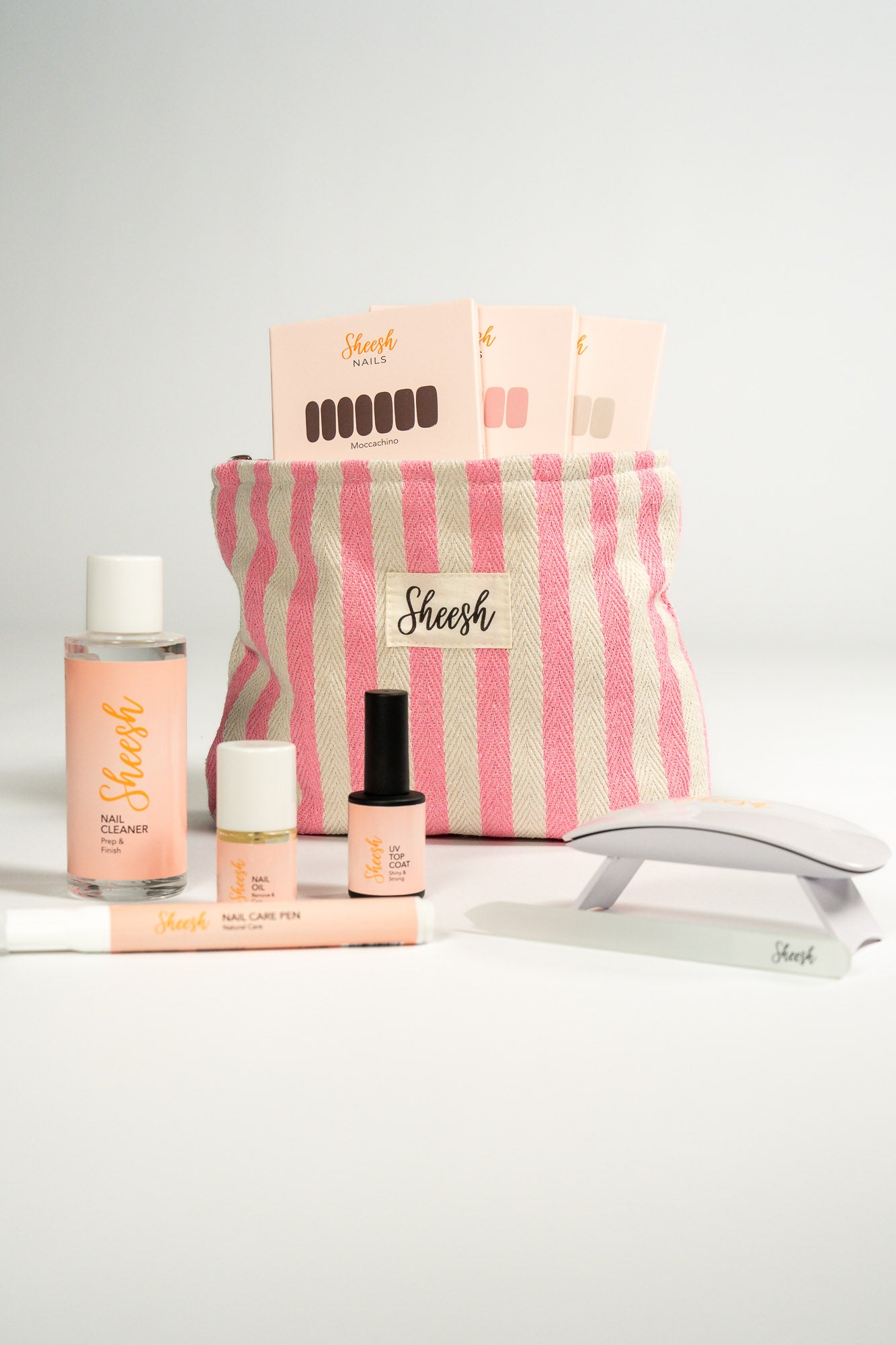 Sheesh Nails Starter Set Pink mit UV-Lampe, Gel Nagelfolien, Top Coat, Nail Cleaner, Nagelöl, Nail Care Pen und gestreifter Kosmetiktasche