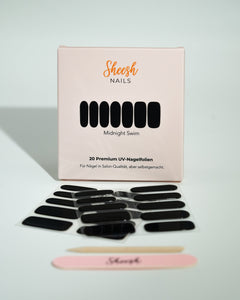 Produktfoto der Sheesh Nails UV-Nagelfolien „Midnight Swim“. Die selbstklebenden Folien in glänzendem Schwarz verleihen den Nägeln einen eleganten, modernen Look in Salonqualität. Im Vordergrund liegen die geöffneten Folien und eine Sheesh-Nagelfeile – ideal für klassische, edle Maniküren mit Tiefenwirkung.